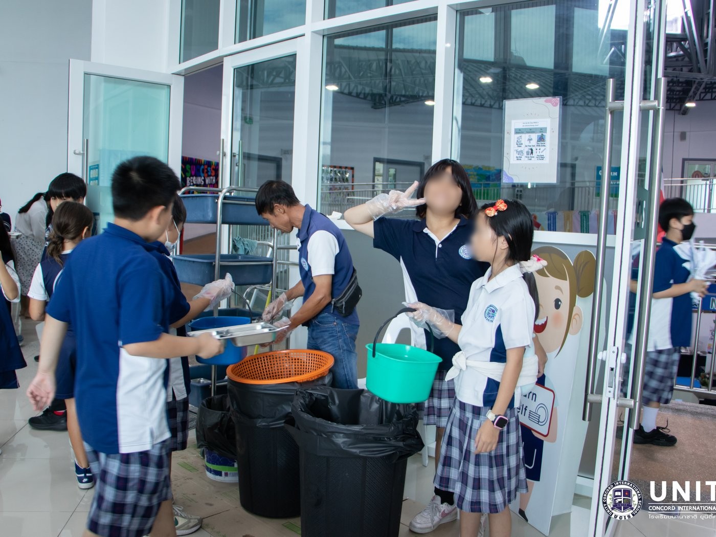 Students sorting cafeteria waste into buckets as part of the compost program