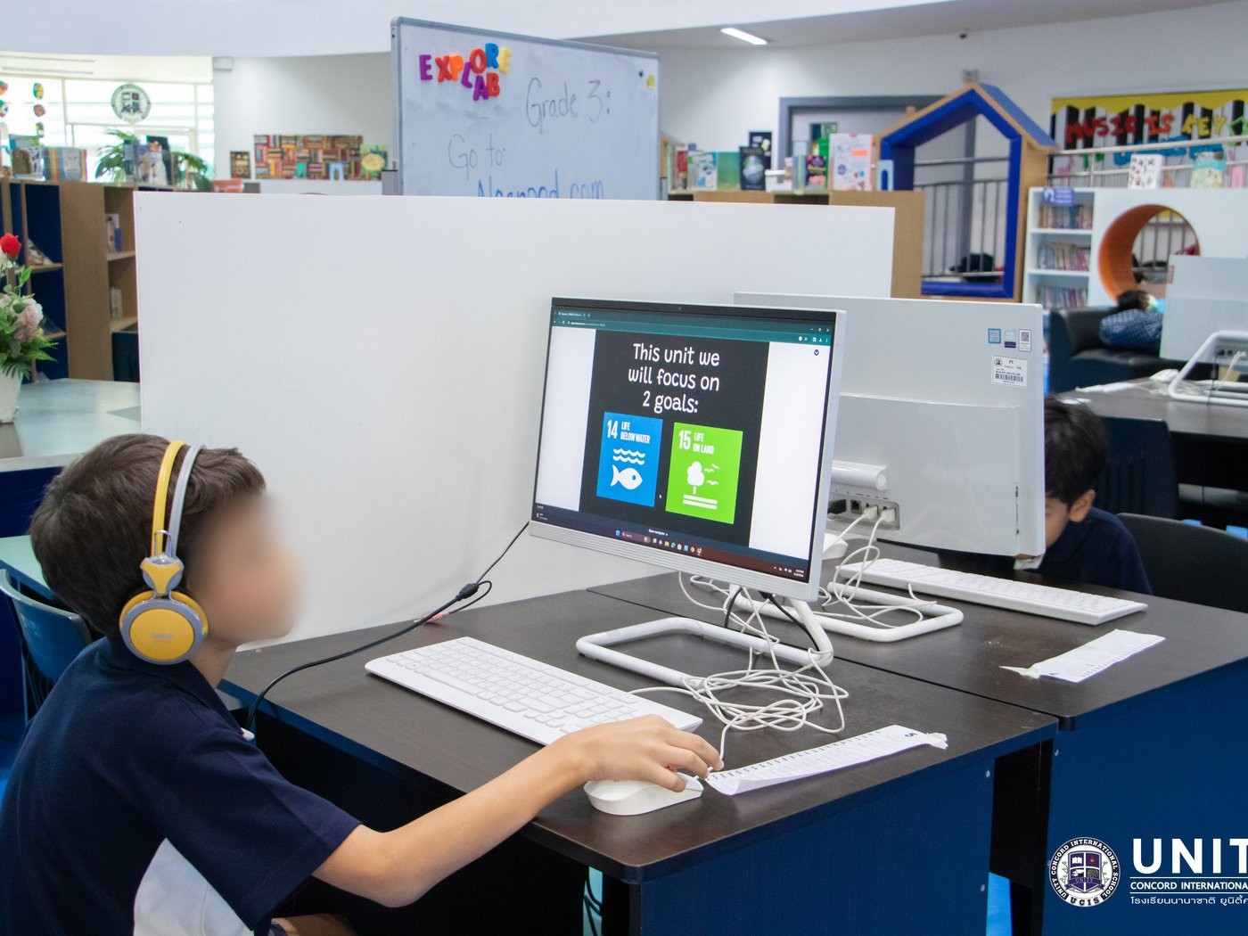 Student at a computer starting a Nearpod lesson focused on Global Goals 14 (Life Below Water) and 15 (Life on Land)