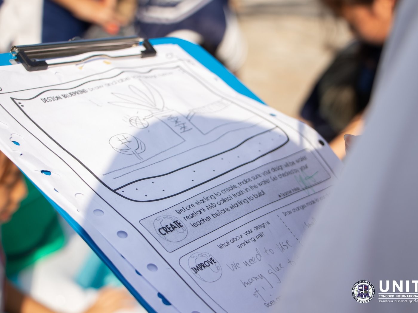 Close-up of a student's design worksheet noting improvements needed after testing their device