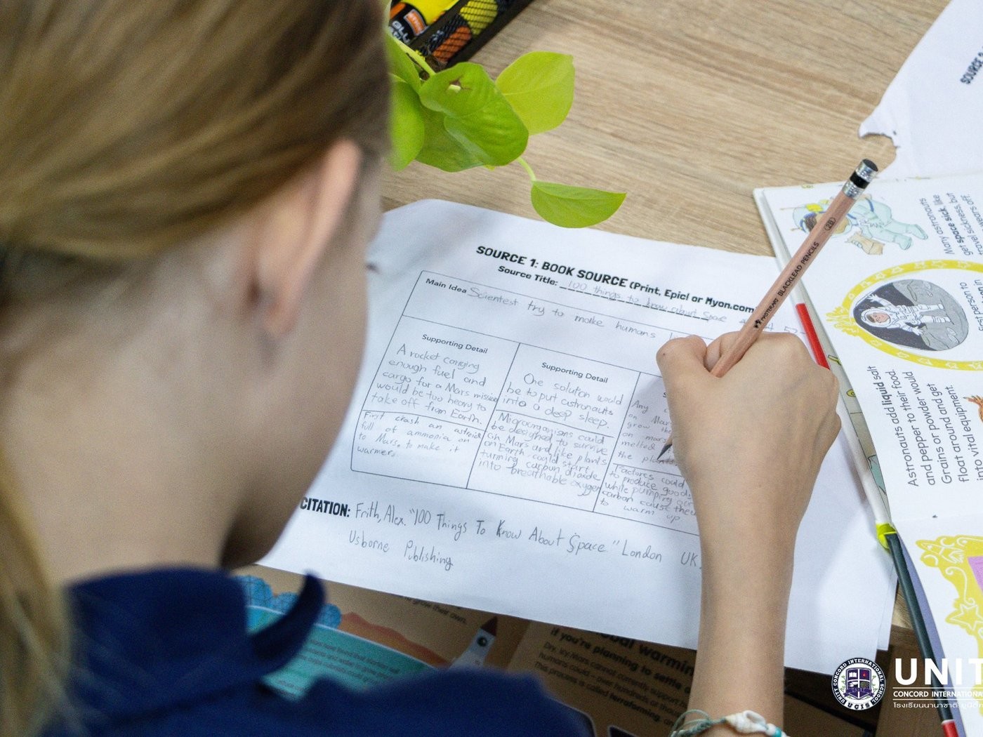 Close-up of a student's book-source citation worksheet, recording the title, author, and publisher for their podcast research