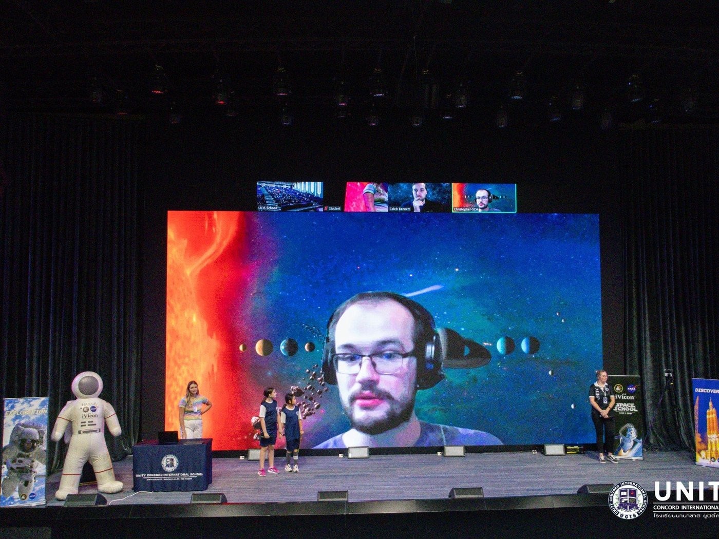 Live video call with a NASA scientist projected on the big screen during the interview