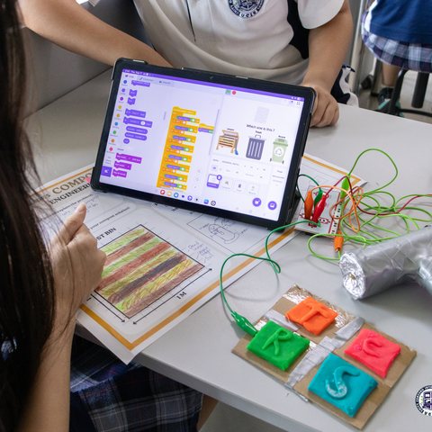 Students sorting compost, recycling, and trash with a Makey Makey and Scratch game