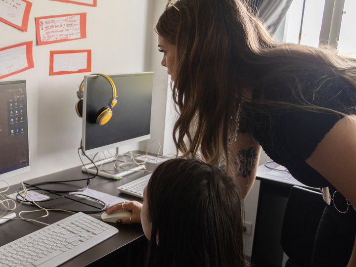 Claire helping a student at the computer