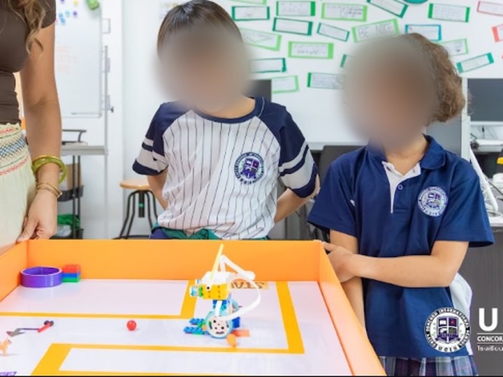 Students testing a LEGO SPIKE robot with Claire
