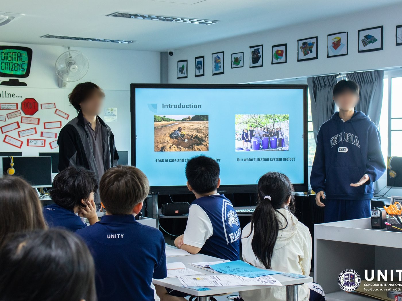 Students presenting their water filtration project to the class, explaining the lack of safe drinking water and their design solution